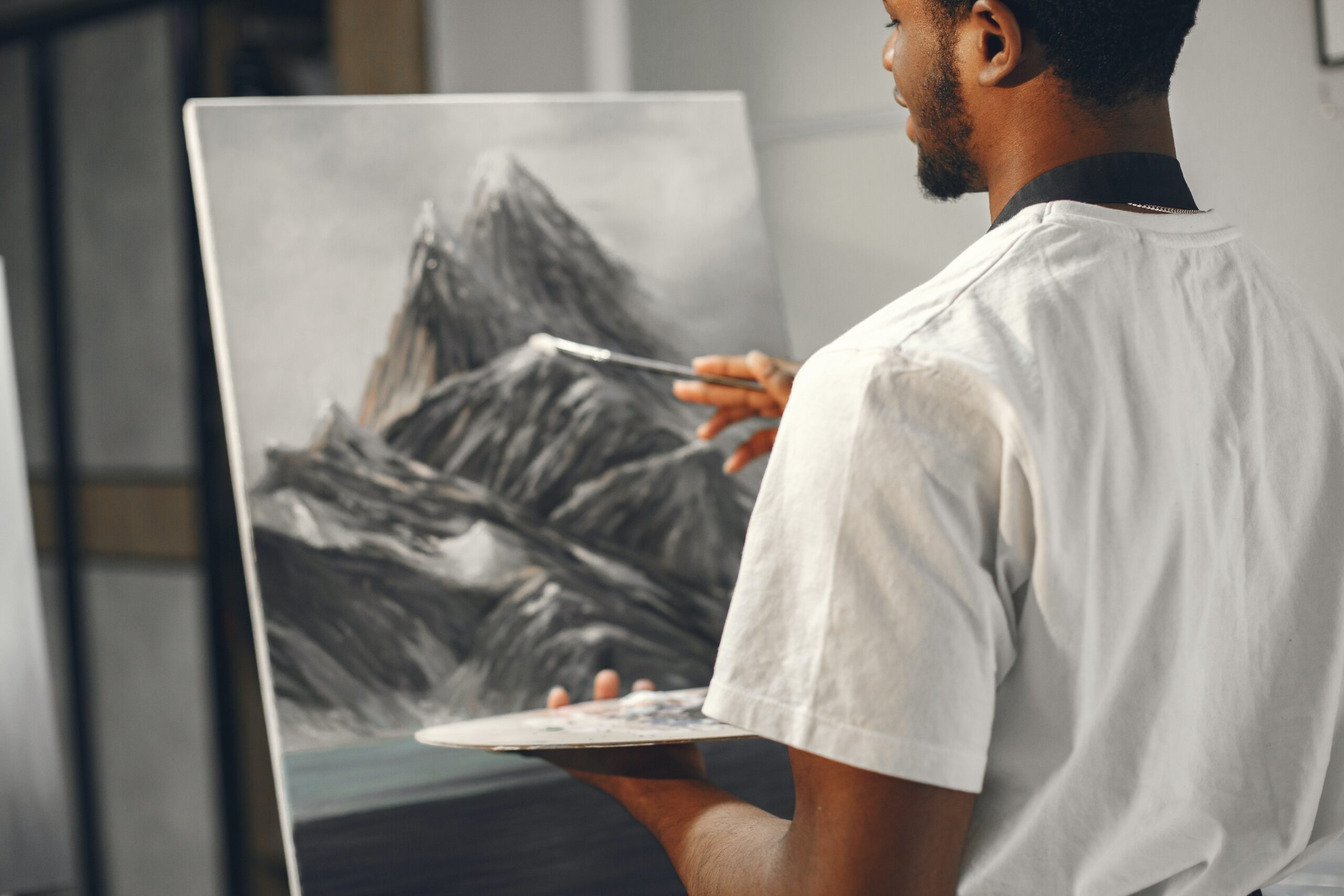 Photo by Gustavo Fring: https://www.pexels.com/photo/man-painting-mountains-on-a-canvas-7446840/